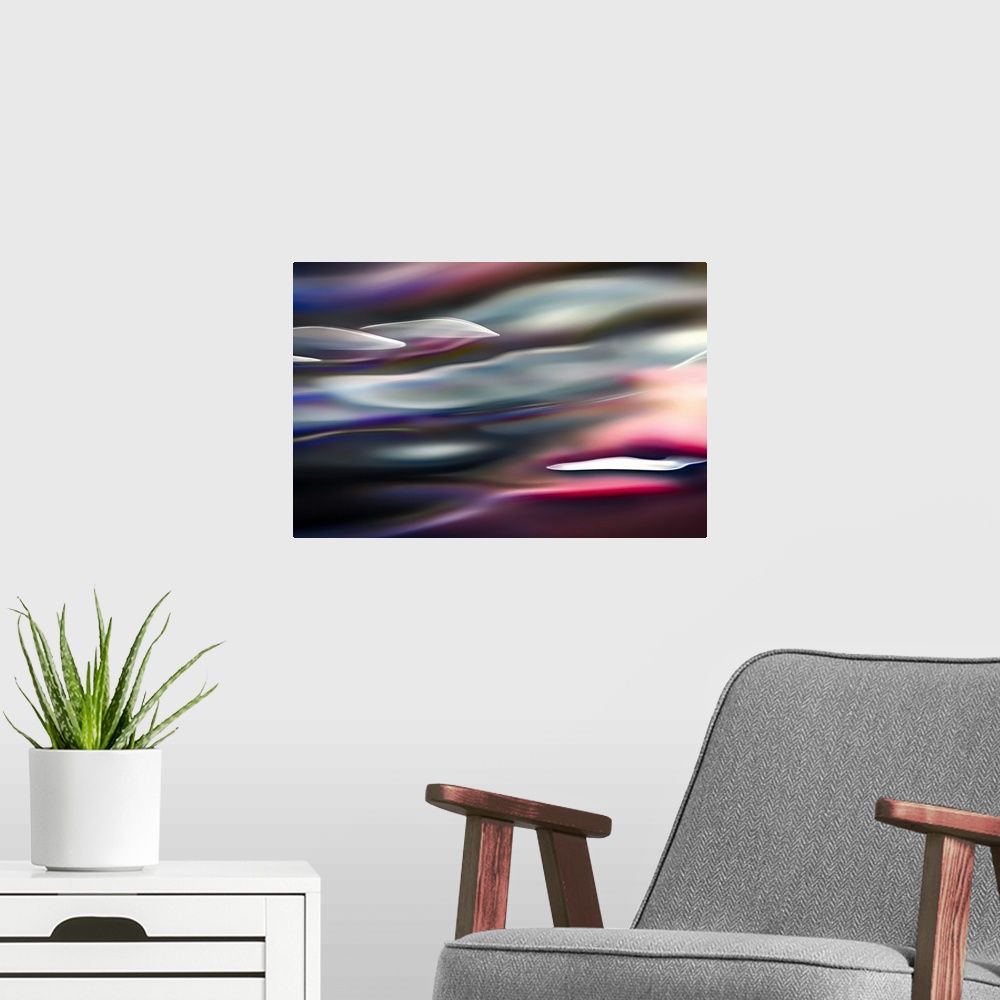 A modern room featuring Abstract photograph in pink and blue shades resembling ocean waves.