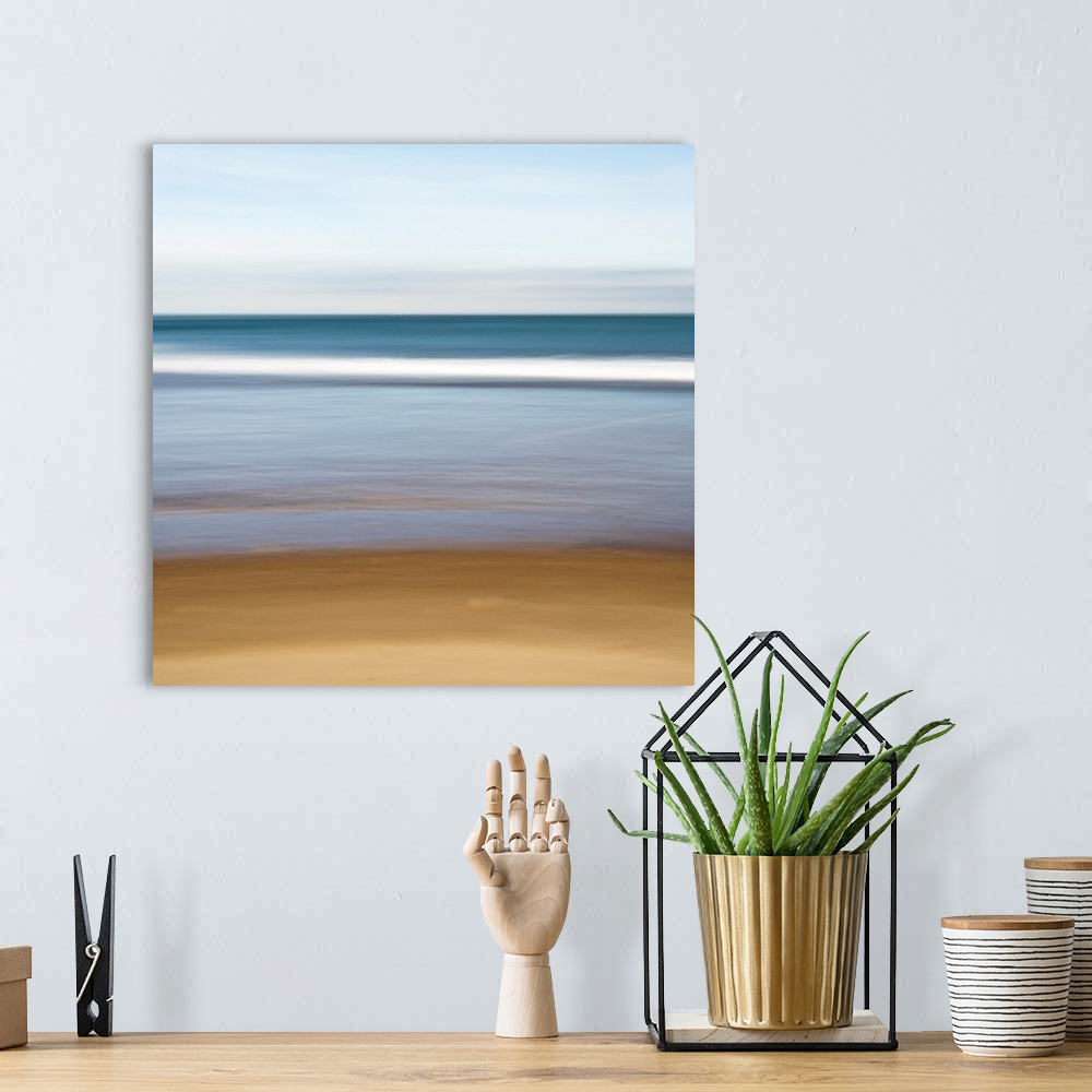 A bohemian room featuring A square canvas of a peaceful seascape with smooth color transitions.