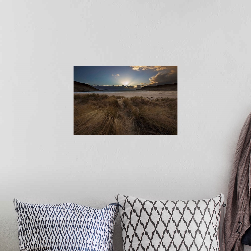 A bohemian room featuring A dramatic seascape sunrise with crepuscular God's Rays from behind clouds with a blue sky and wi...