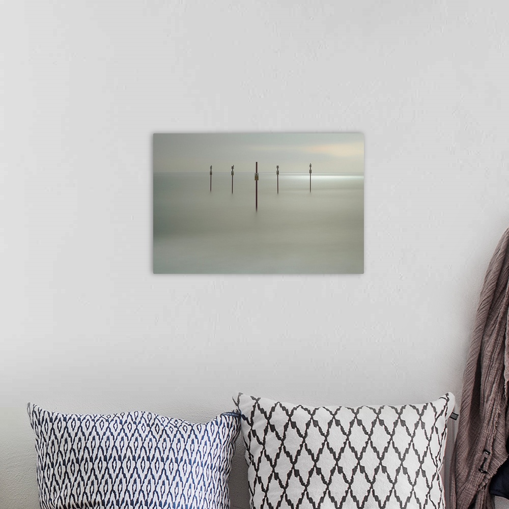 A bohemian room featuring Fine art photograph of sign posts in a clam sea shore.