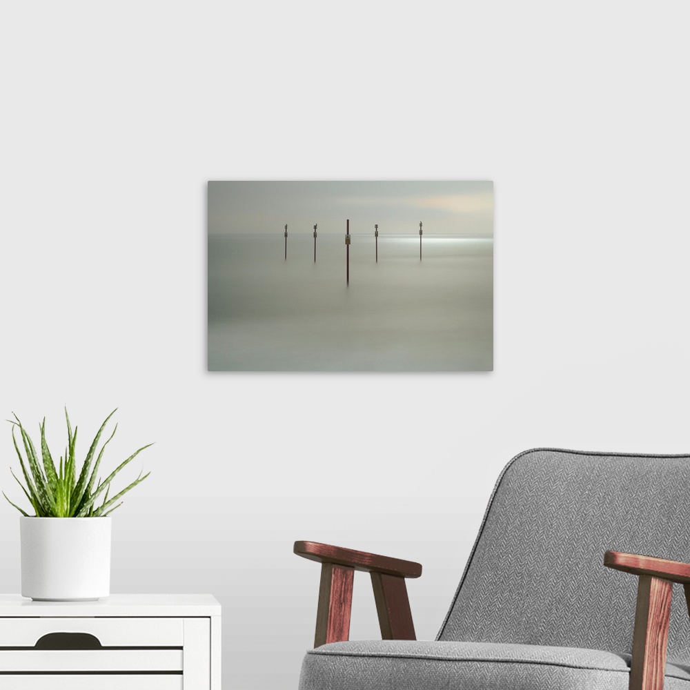 A modern room featuring Fine art photograph of sign posts in a clam sea shore.