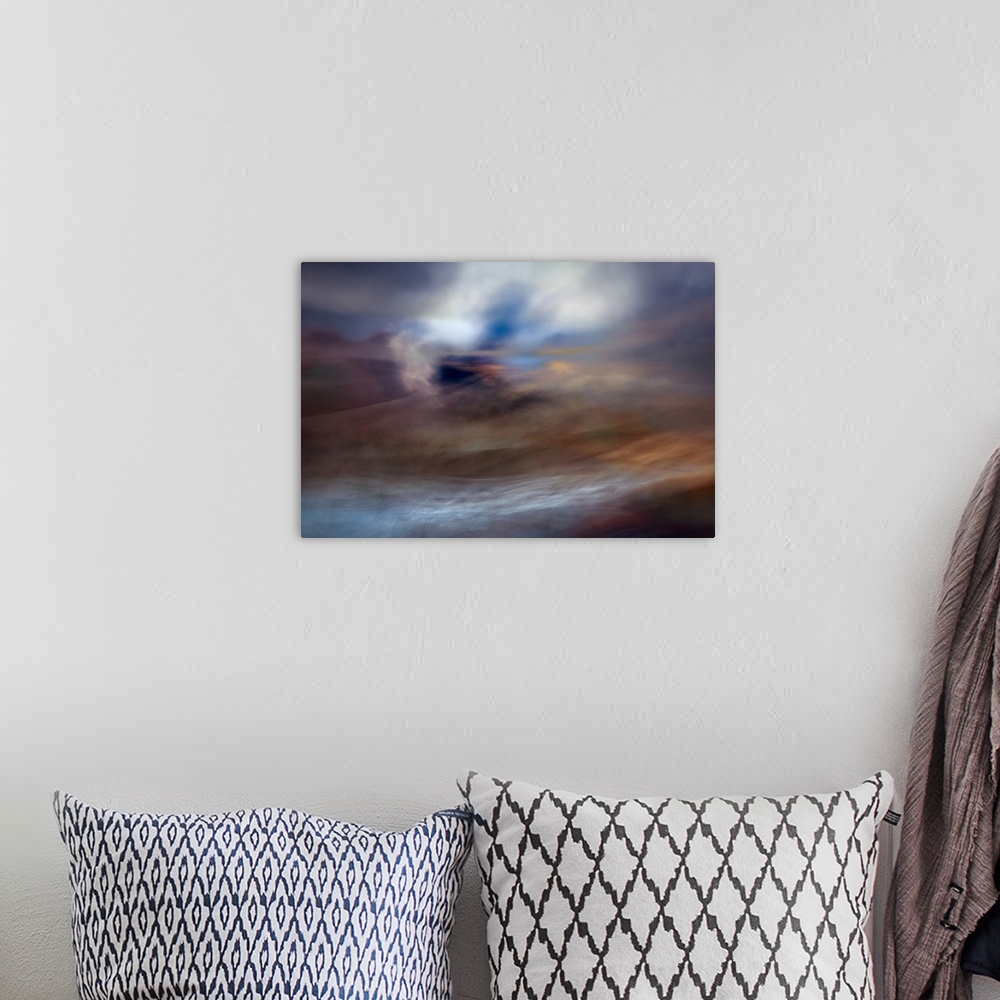 A bohemian room featuring An impressionistic dreamy blurred Turneresque seascape of swirling water and sky in blues, orange...