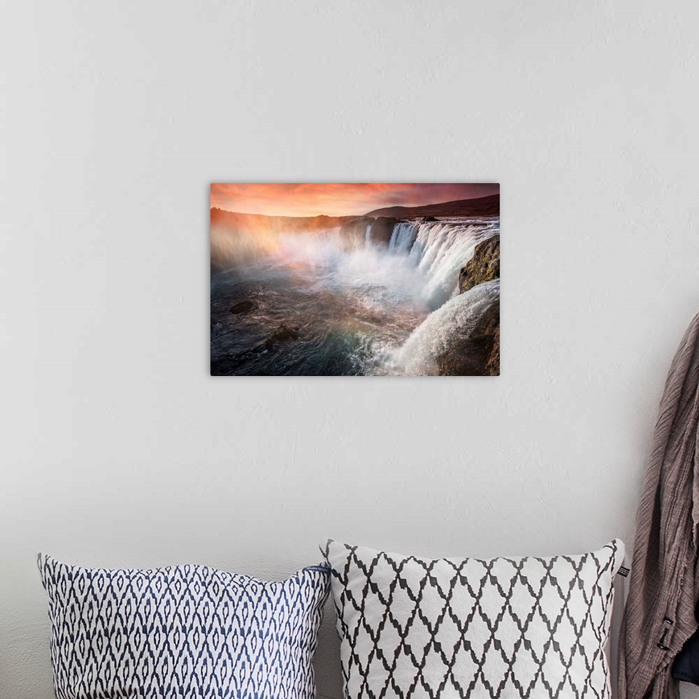 A bohemian room featuring Fine art photograph of a large series of waterfalls with orange sunlight shining down.