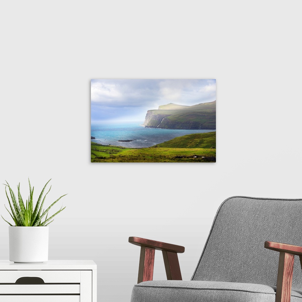A modern room featuring Fine art photo of cliffs at the edge of the sea under bright sunlight.