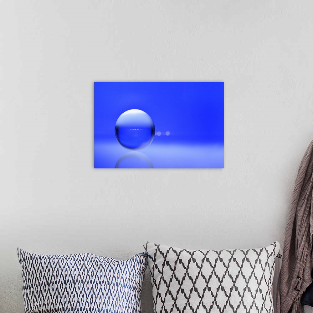 A bohemian room featuring A macro photograph of a water droplet on a blue surface.