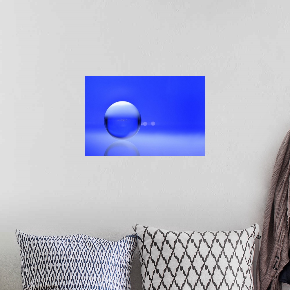 A bohemian room featuring A macro photograph of a water droplet on a blue surface.