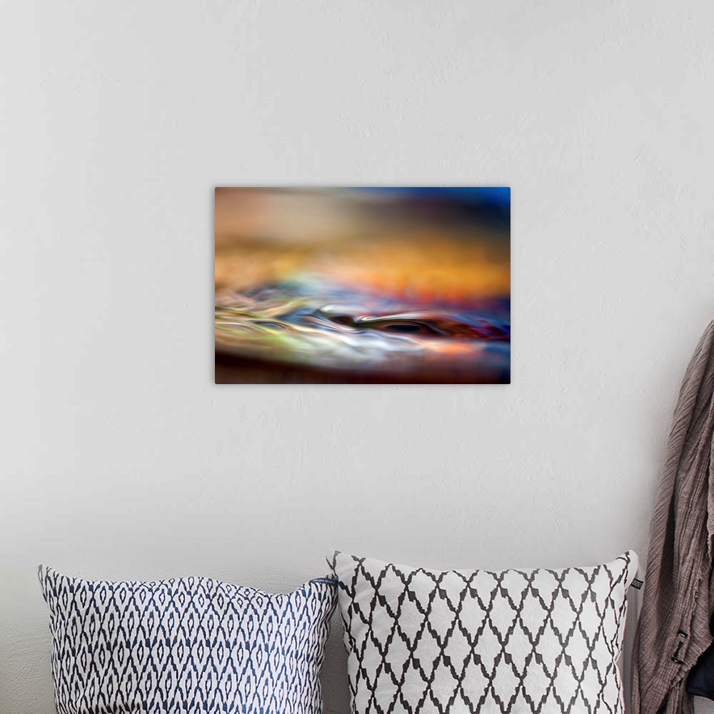 A bohemian room featuring Abstract photograph of smooth liquid undulations reflecting various evening hues with a shallow d...