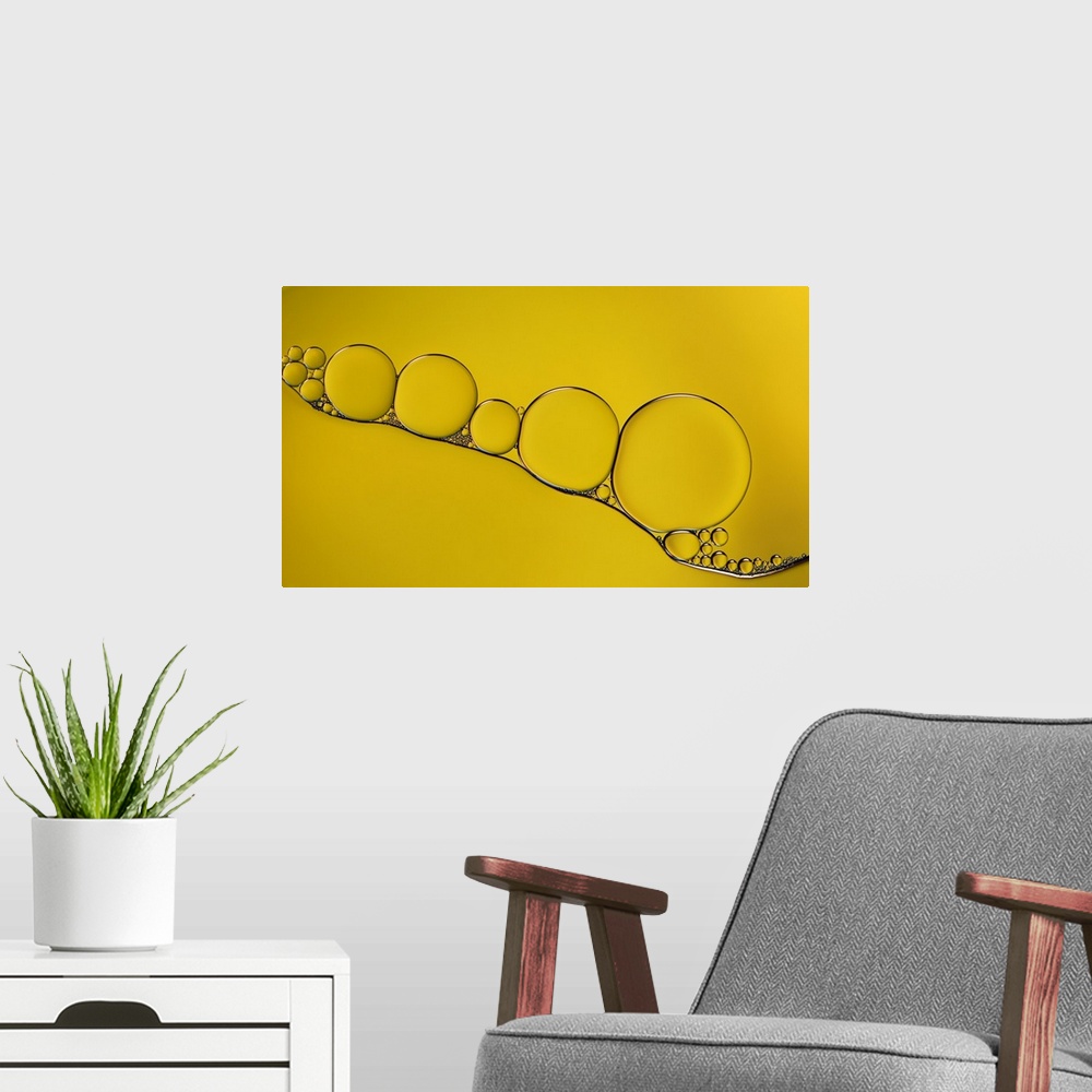 A modern room featuring A macro photograph of water bubbles against a yellow surface.