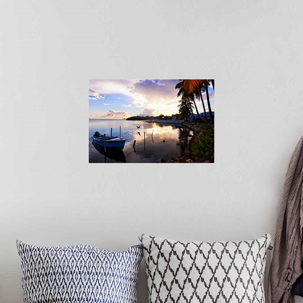 A bohemian room featuring Large landscape photograph of the sun setting over the coast near a fishing village in La Parguer...