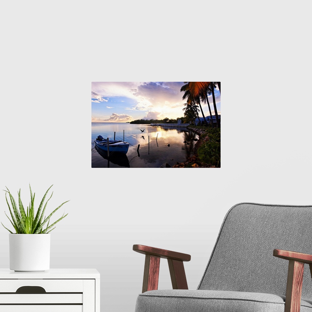A modern room featuring Large landscape photograph of the sun setting over the coast near a fishing village in La Parguer...