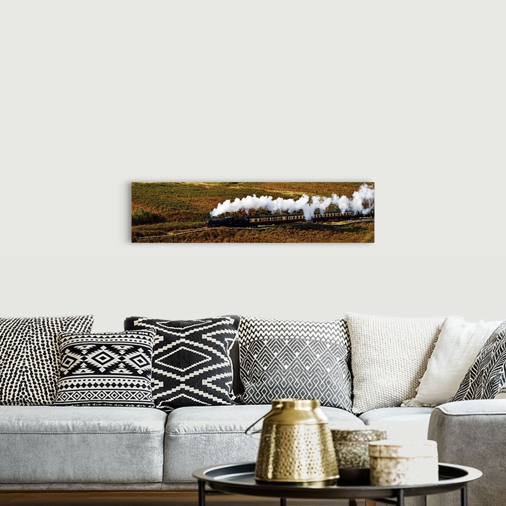 A bohemian room featuring A steam train panorama as the train flows through a moorland landscape in Yorkshire, UK, with ste...