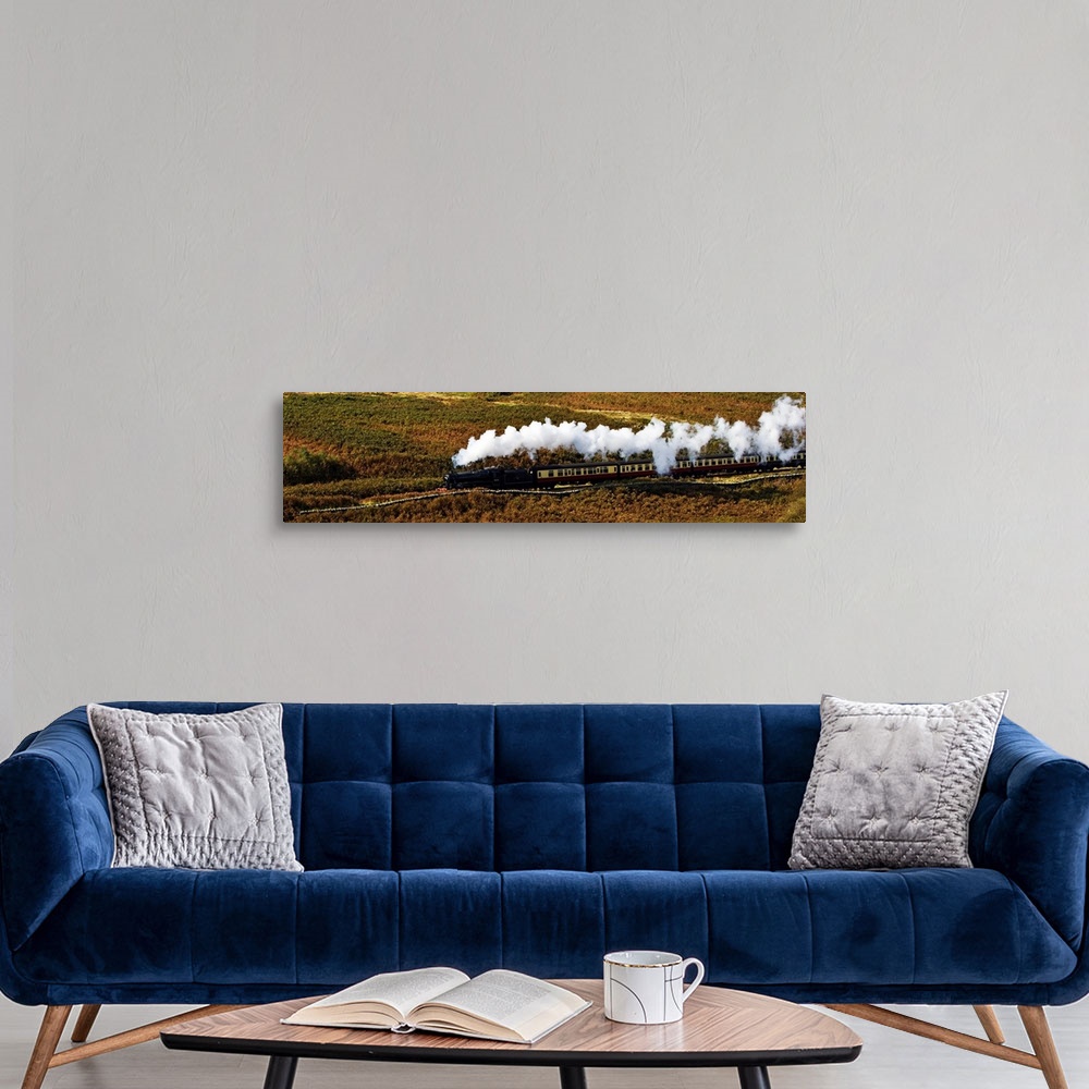 A modern room featuring A steam train panorama as the train flows through a moorland landscape in Yorkshire, UK, with ste...