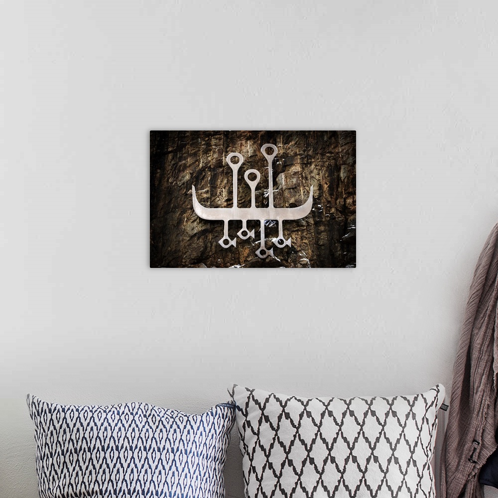 A bohemian room featuring A photograph of a tributary metal carved symbol of the vikings.
