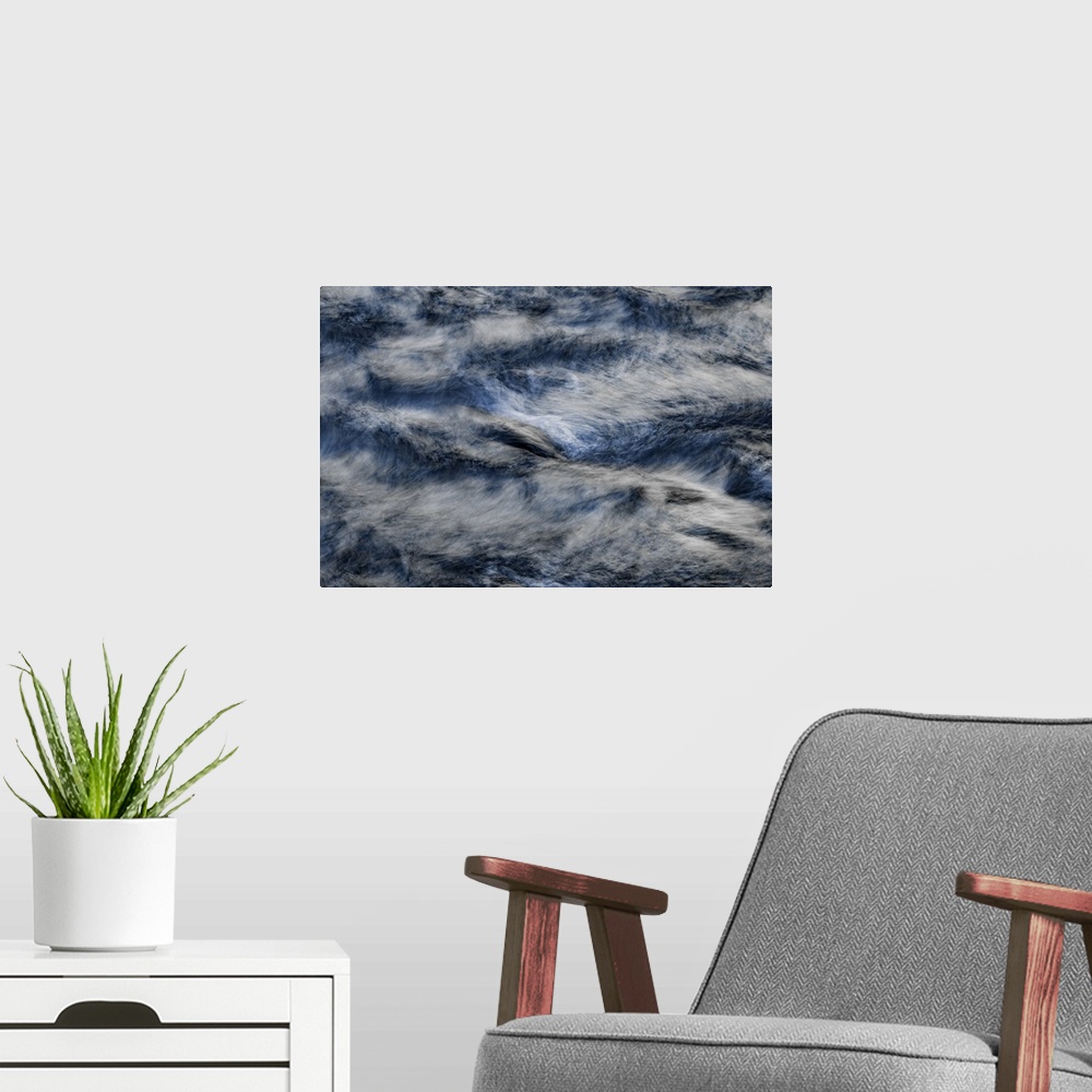 A modern room featuring A contemporary natural abstract of deep silvery blue rushing water swirling around the frame.