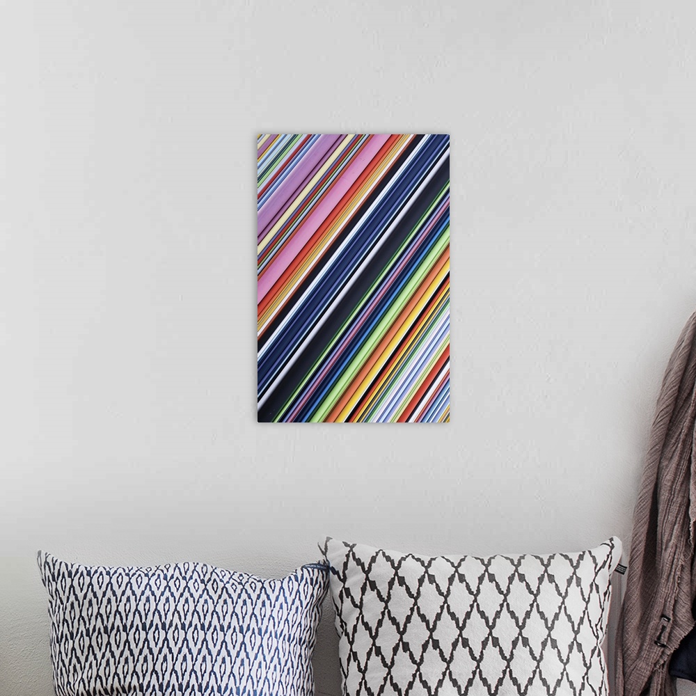 A bohemian room featuring A contemporary energetic rainbow hued abstract with diagonal lines of many shades of colour.