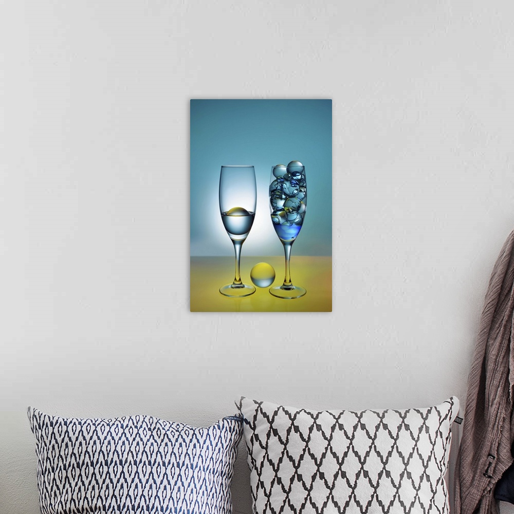 A bohemian room featuring A photograph of glass orbs sitting in tall wine glasses.
