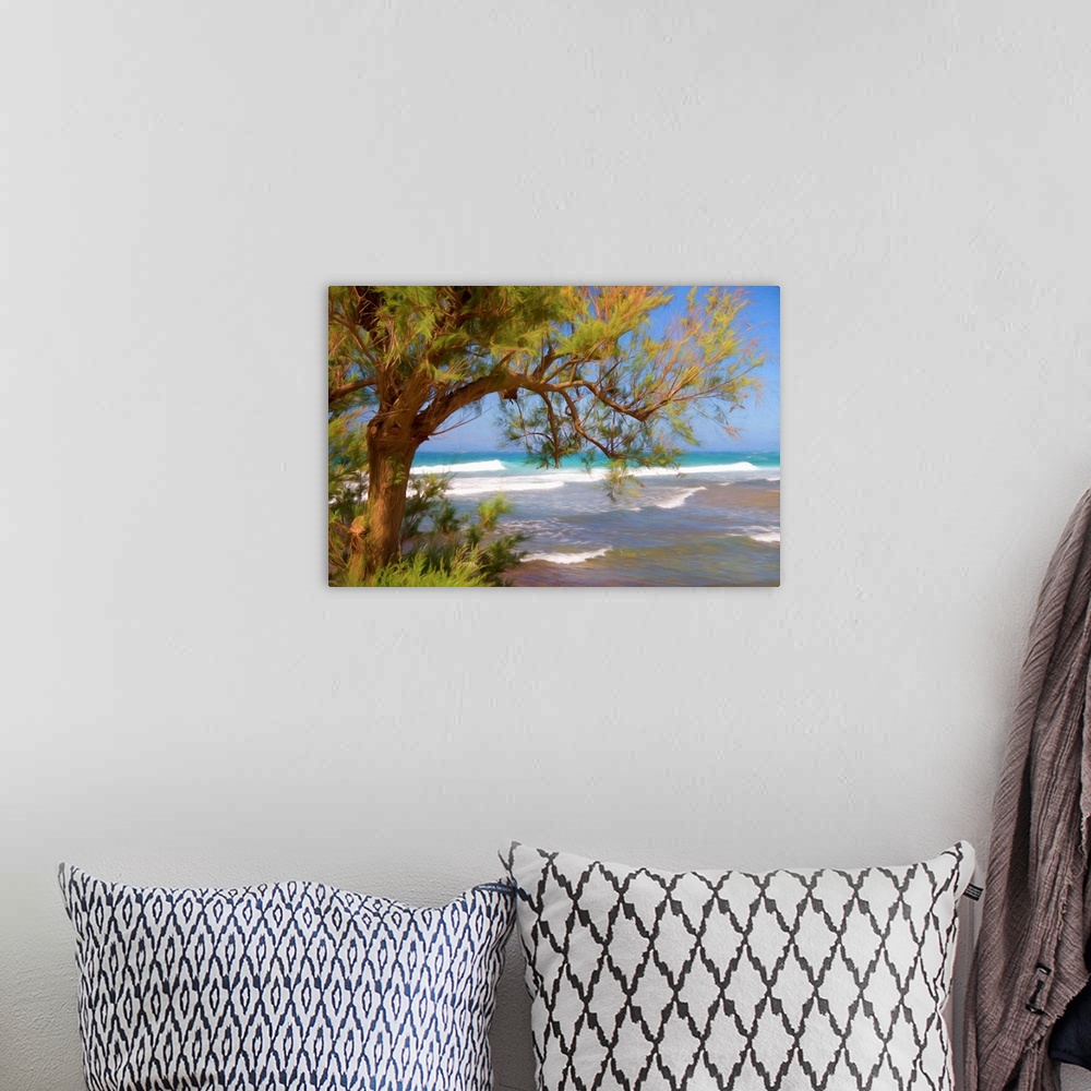 A bohemian room featuring A photograph of a beach seen through the underside of a trees hanging branches.