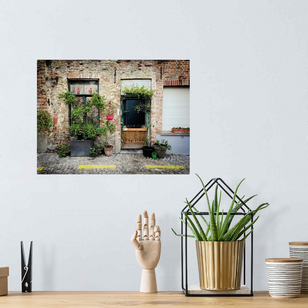 A bohemian room featuring A photo of brick building covered in plants from a street view.