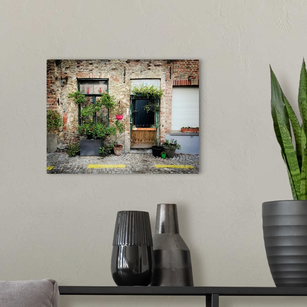 A modern room featuring A photo of brick building covered in plants from a street view.