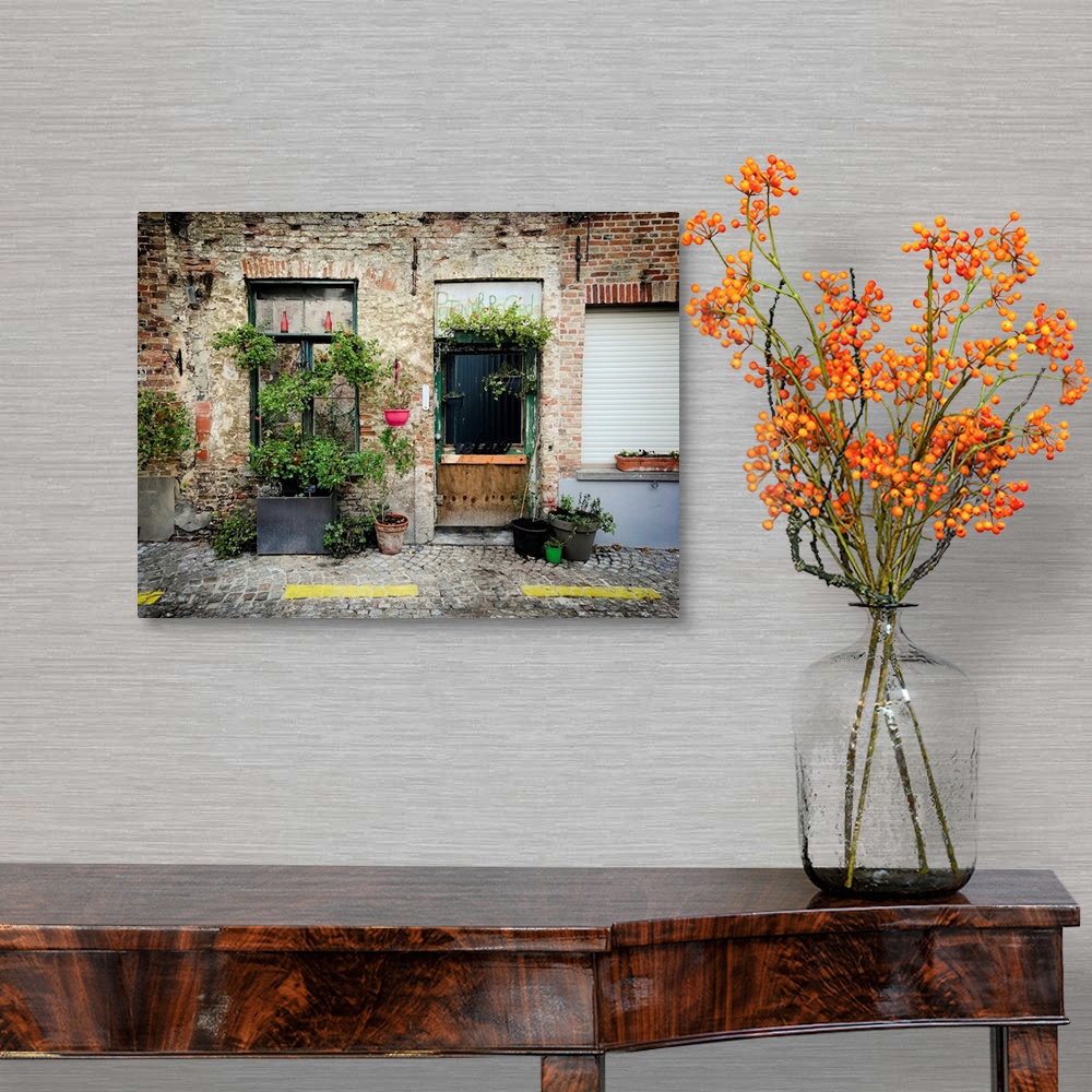 A traditional room featuring A photo of brick building covered in plants from a street view.