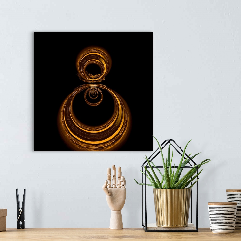 A bohemian room featuring Square abstract art with gold circles formed together on a black background.