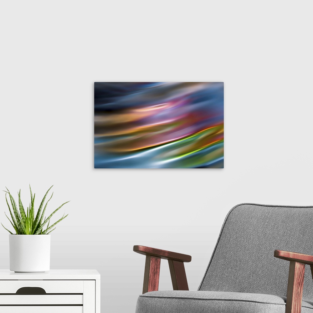 A modern room featuring Abstract photograph in warm colors resembling ocean waves.