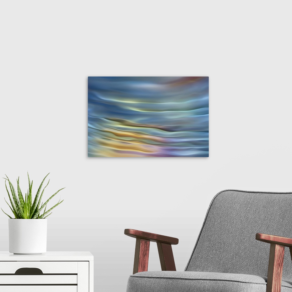 A modern room featuring Abstract photograph in pastel yellow and blue shades resembling ocean waves.