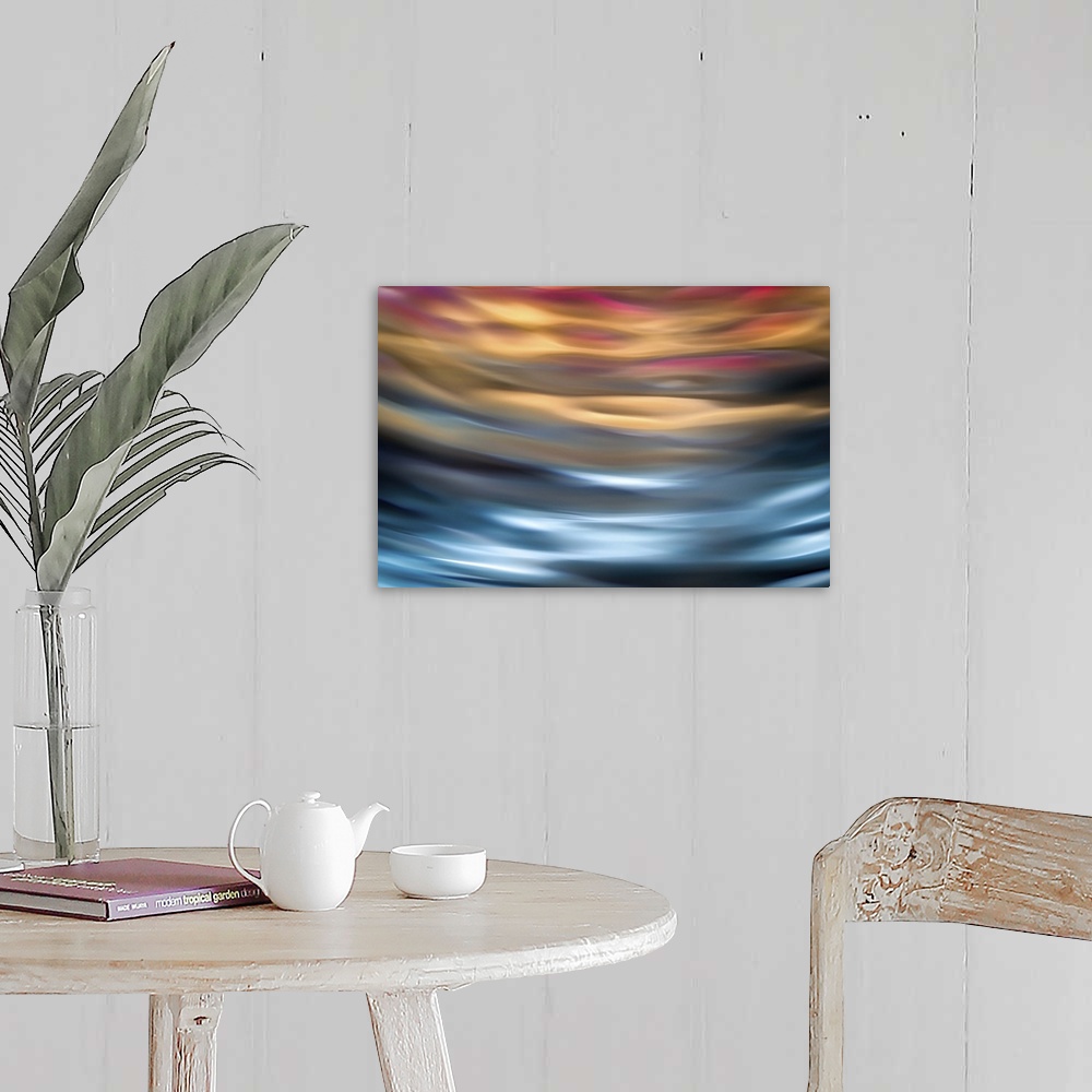 A farmhouse room featuring Abstract photograph in orange and blue shades resembling ocean waves.