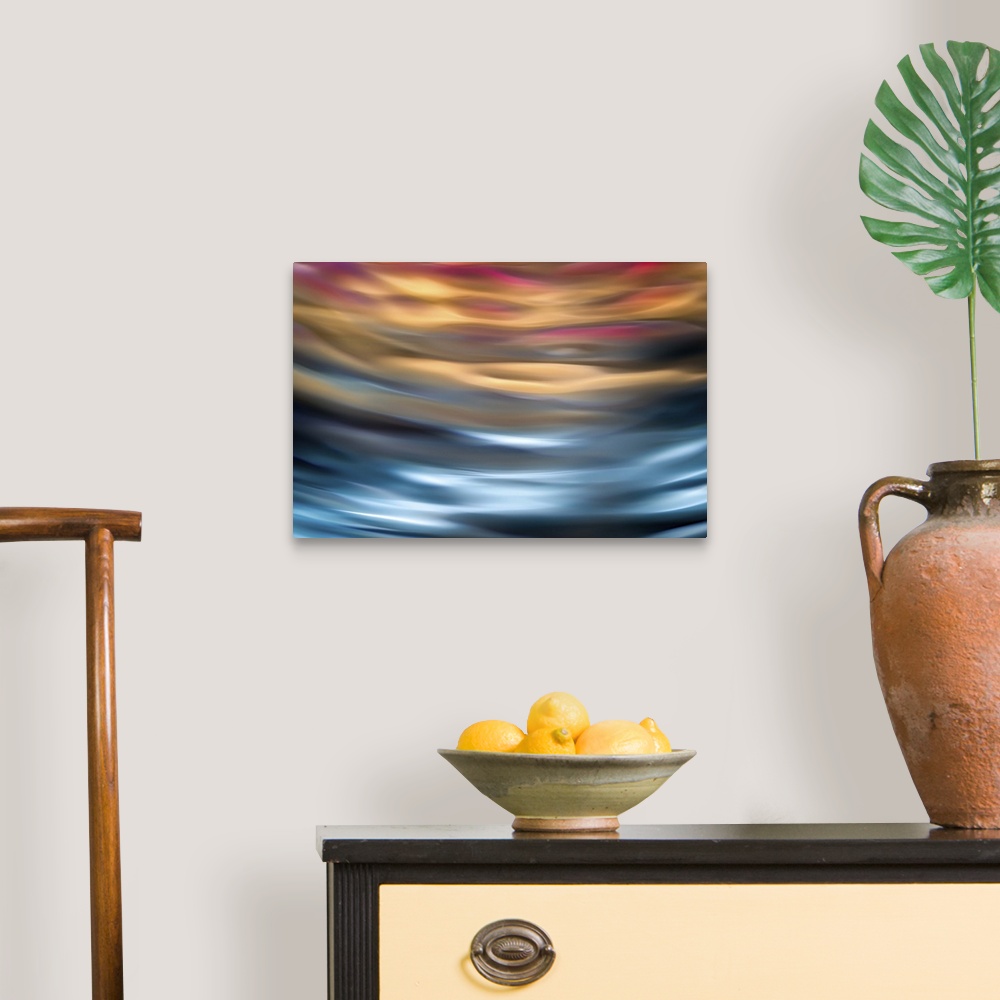 A traditional room featuring Abstract photograph in orange and blue shades resembling ocean waves.