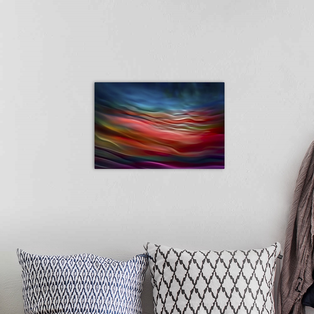 A bohemian room featuring Abstract photograph in blue and red shades resembling ocean waves.