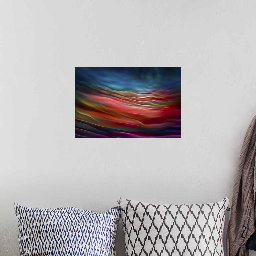 A bohemian room featuring Abstract photograph in blue and red shades resembling ocean waves.