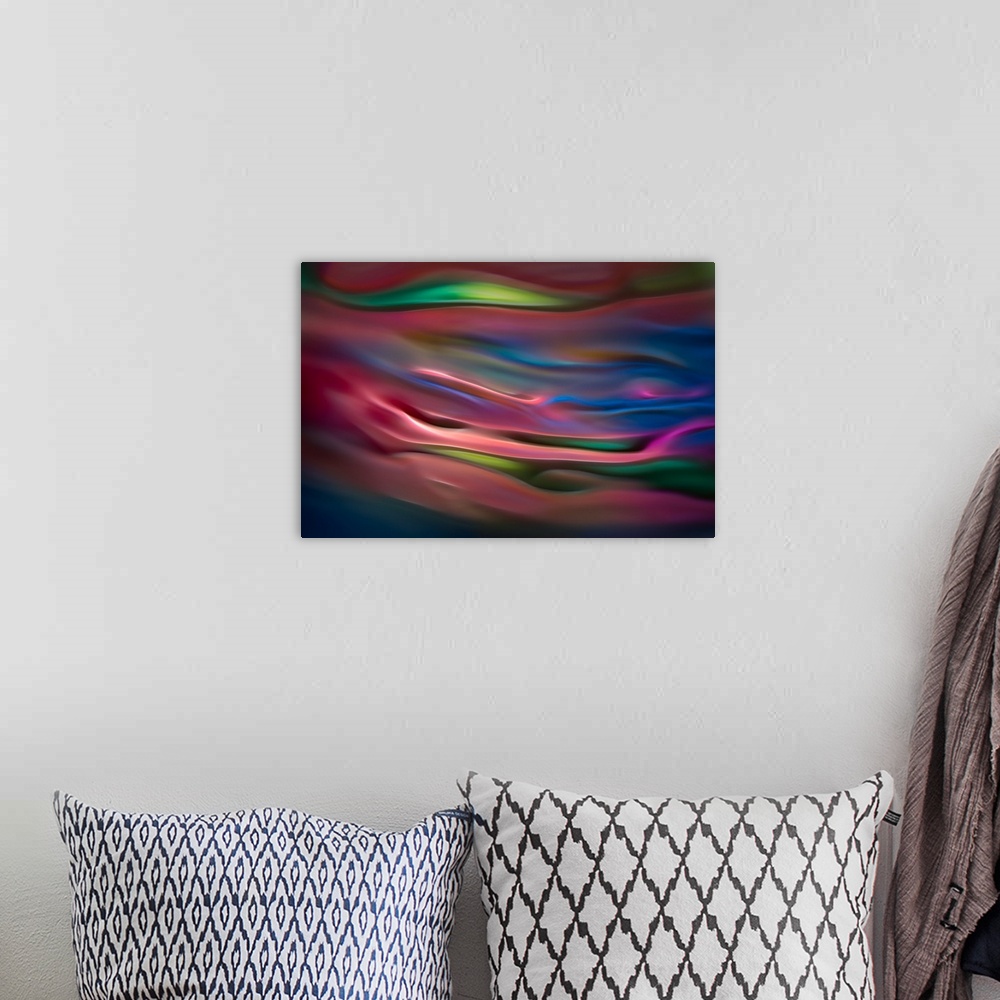 A bohemian room featuring Abstract photograph in pink and blue shades resembling ocean waves.
