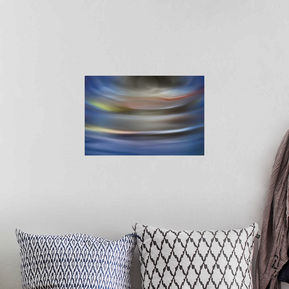 A bohemian room featuring Abstract photograph in grey and blue shades resembling ocean waves.