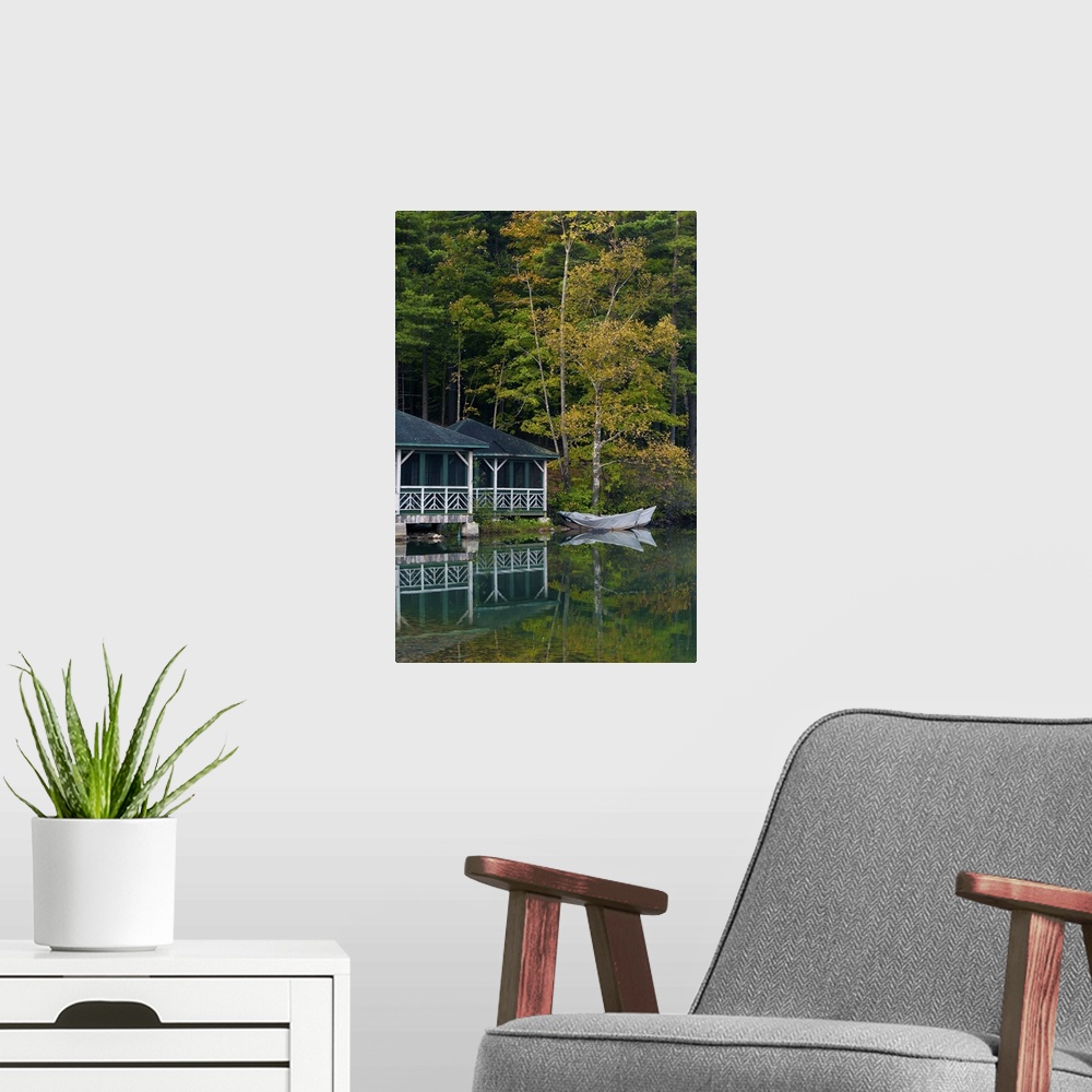 A modern room featuring Early morning scene of a beautiful and colorful lakeside boathouse with ornate white railings sur...