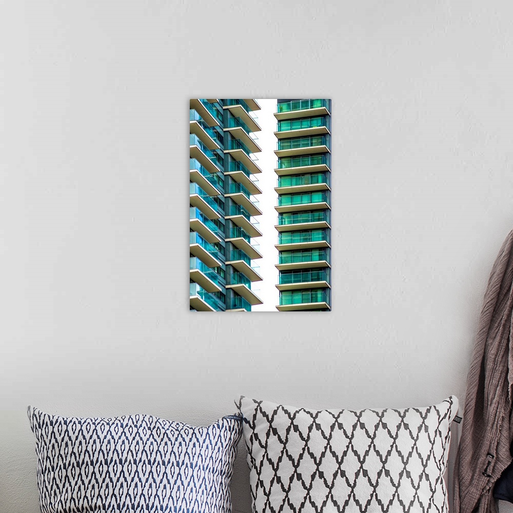 A bohemian room featuring A photograph of blue and green glass buildings.