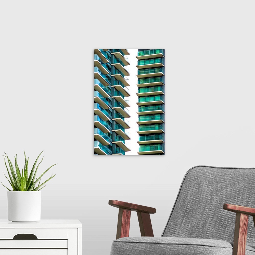 A modern room featuring A photograph of blue and green glass buildings.