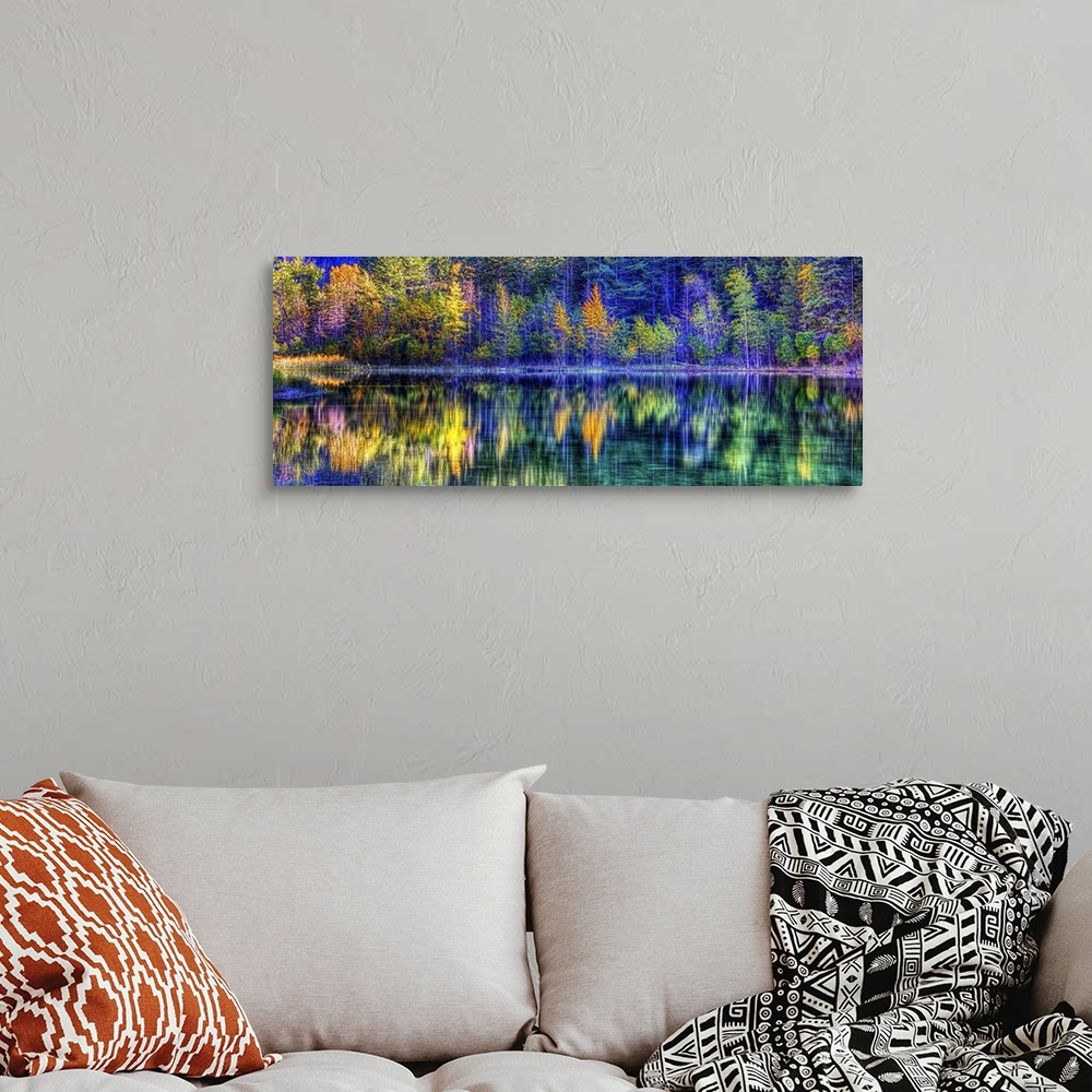 A bohemian room featuring A colorful scene of fall trees reflecting on the water.