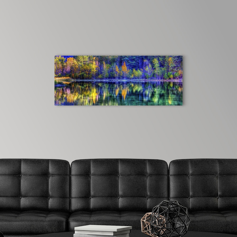 A modern room featuring A colorful scene of fall trees reflecting on the water.