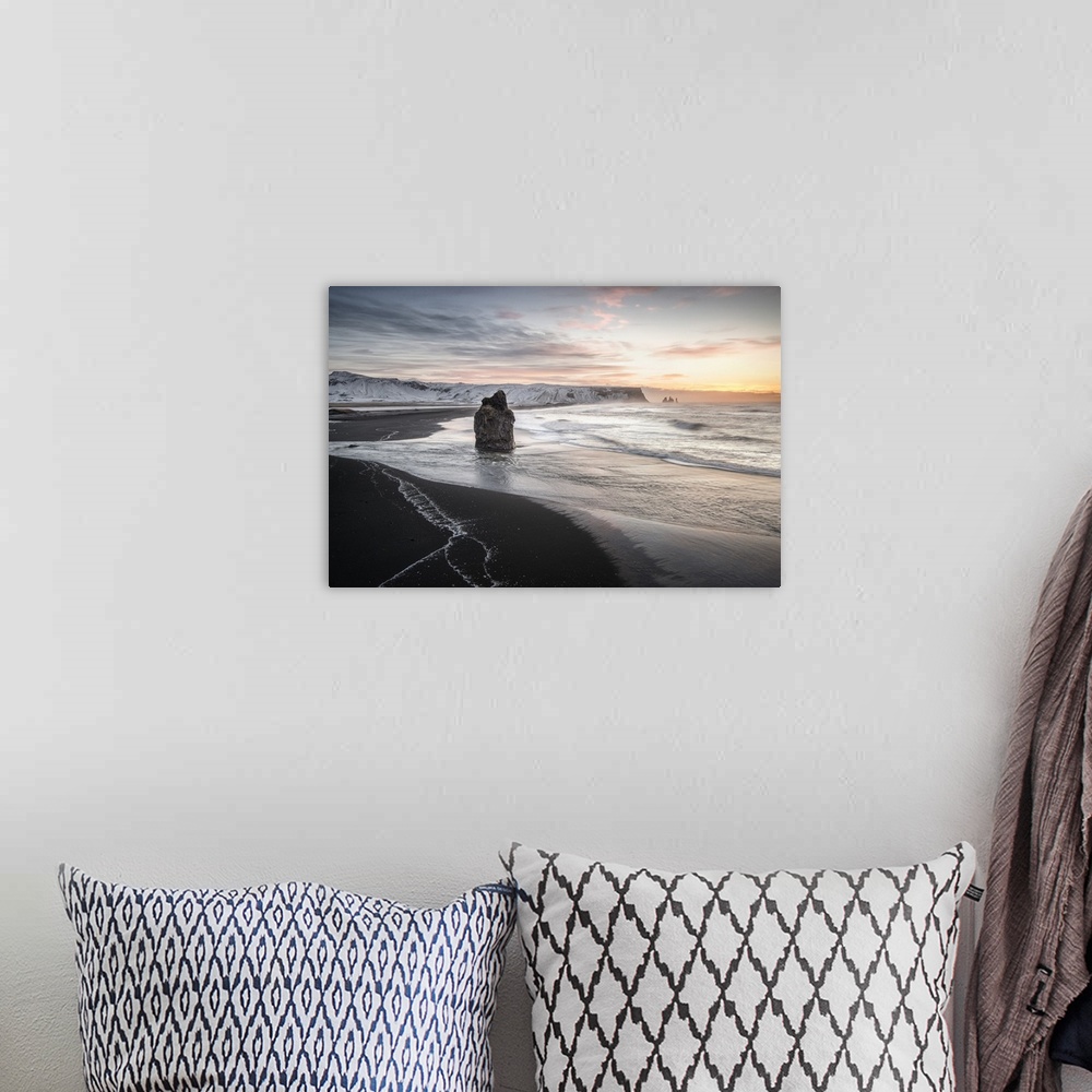 A bohemian room featuring Pastel sunset sky over the coast of Vik, Iceland, with a glacier in the distance.