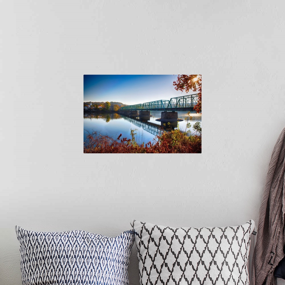 A bohemian room featuring Fine art photo of a bridge crossing a wide river in New Jersey.