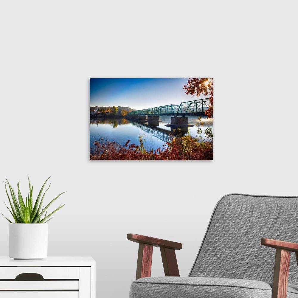 A modern room featuring Fine art photo of a bridge crossing a wide river in New Jersey.