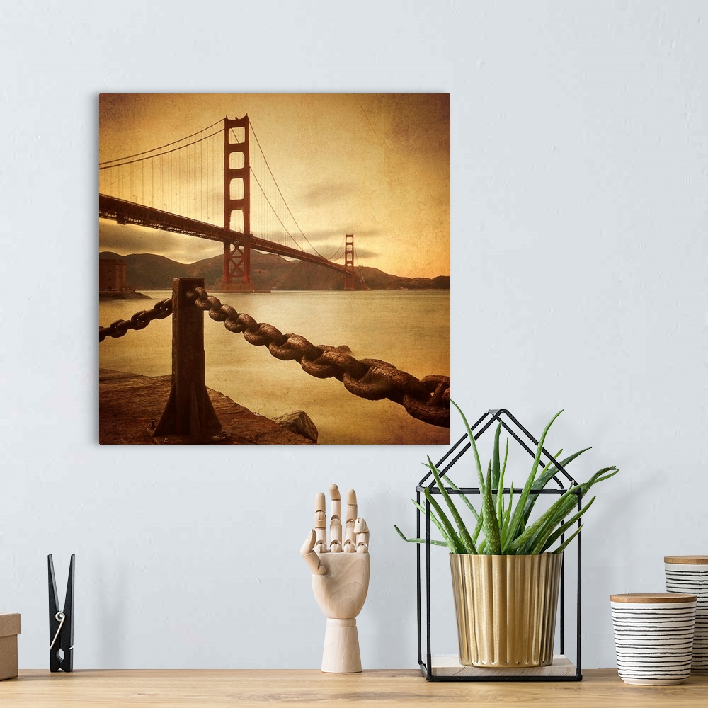 A bohemian room featuring This large square print is a low angle view of the Golden Gate Bridge from land where there is a ...