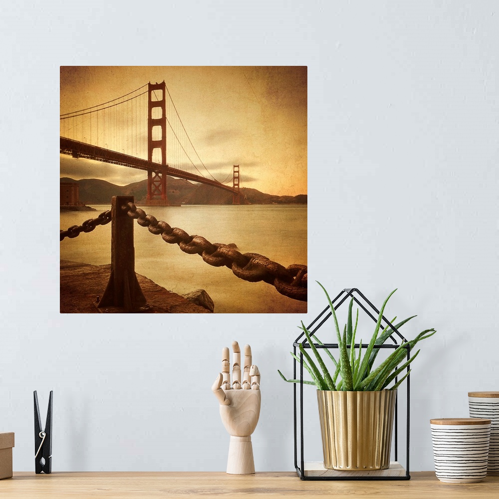 A bohemian room featuring This large square print is a low angle view of the Golden Gate Bridge from land where there is a ...