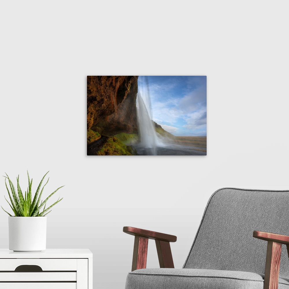 A modern room featuring Fine art photograph of a tall waterfall in Iceland.