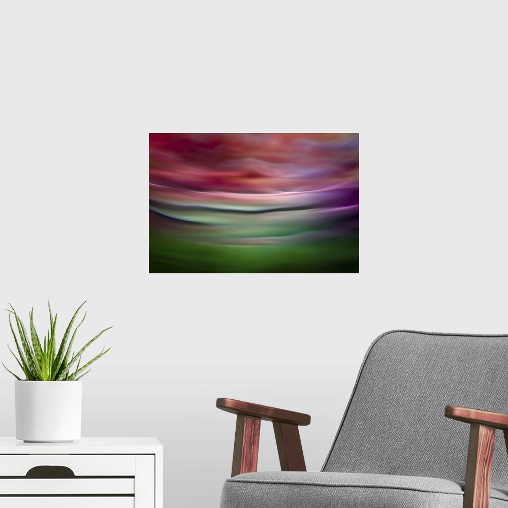 A modern room featuring Abstract photograph in green and red shades resembling ocean waves.