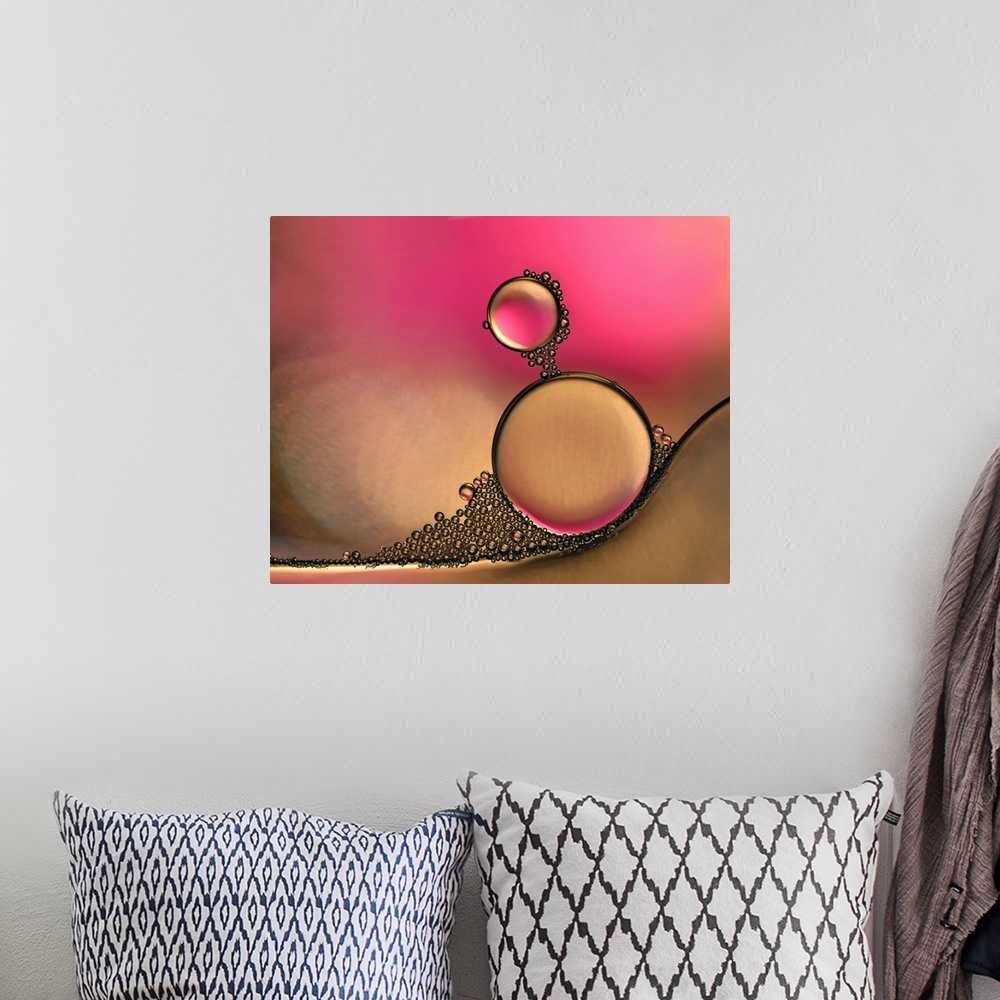 A bohemian room featuring Macro photograph of drops of oil in water with pink and orange hues.