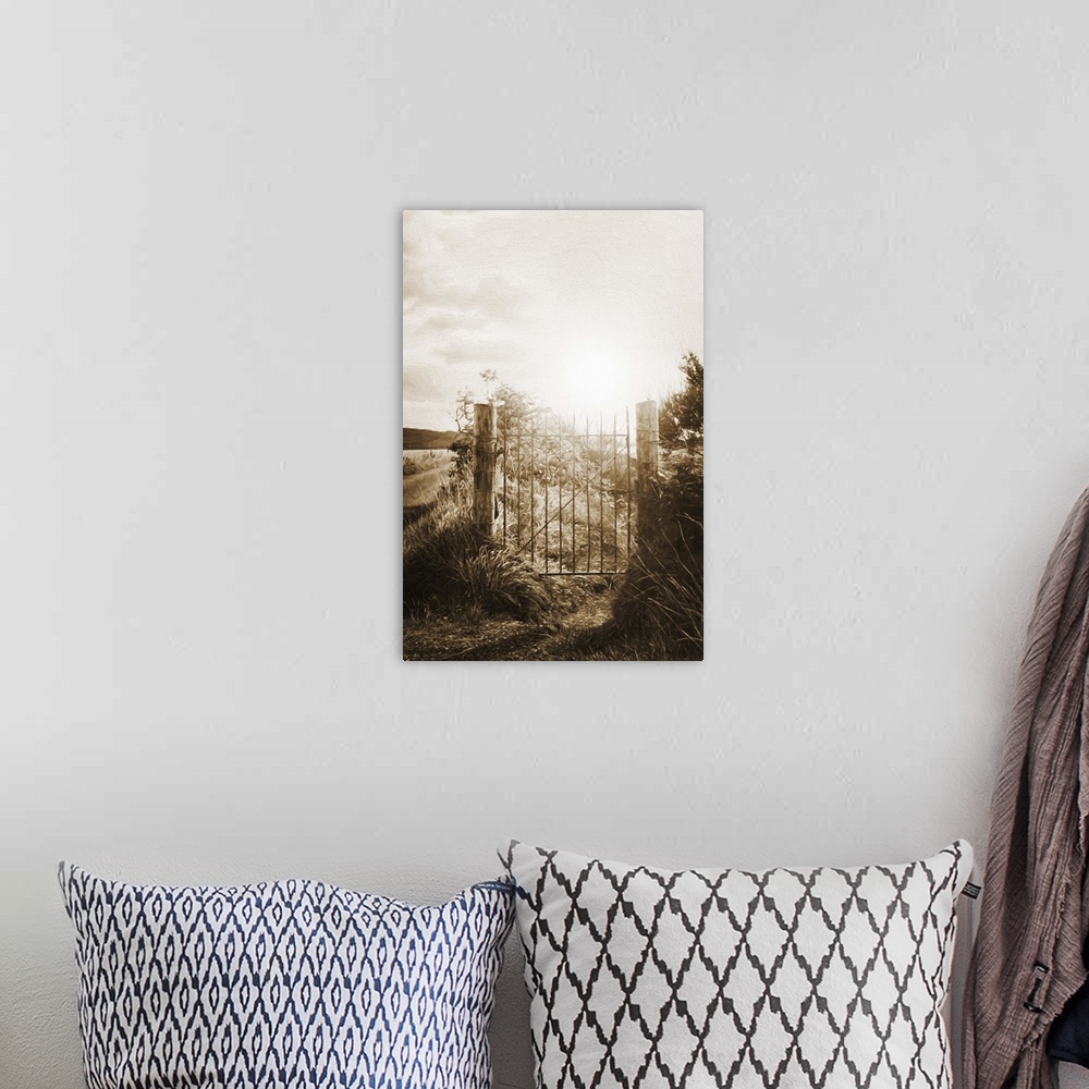 A bohemian room featuring A photograph of a gate fence gate silhouetted by a rising sun.