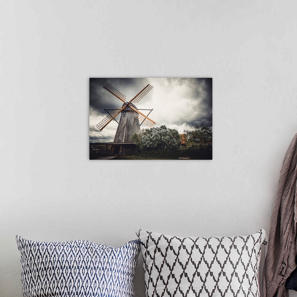 A bohemian room featuring Old windmill in front of a stormy sky