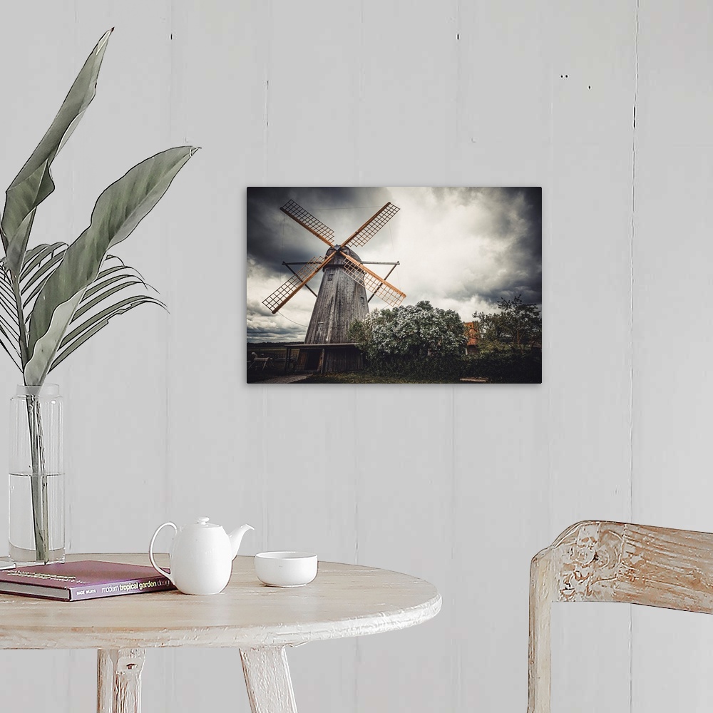 A farmhouse room featuring Old windmill in front of a stormy sky