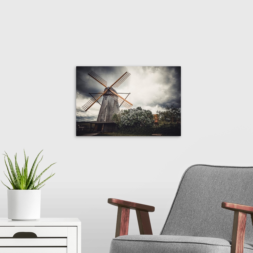 A modern room featuring Old windmill in front of a stormy sky